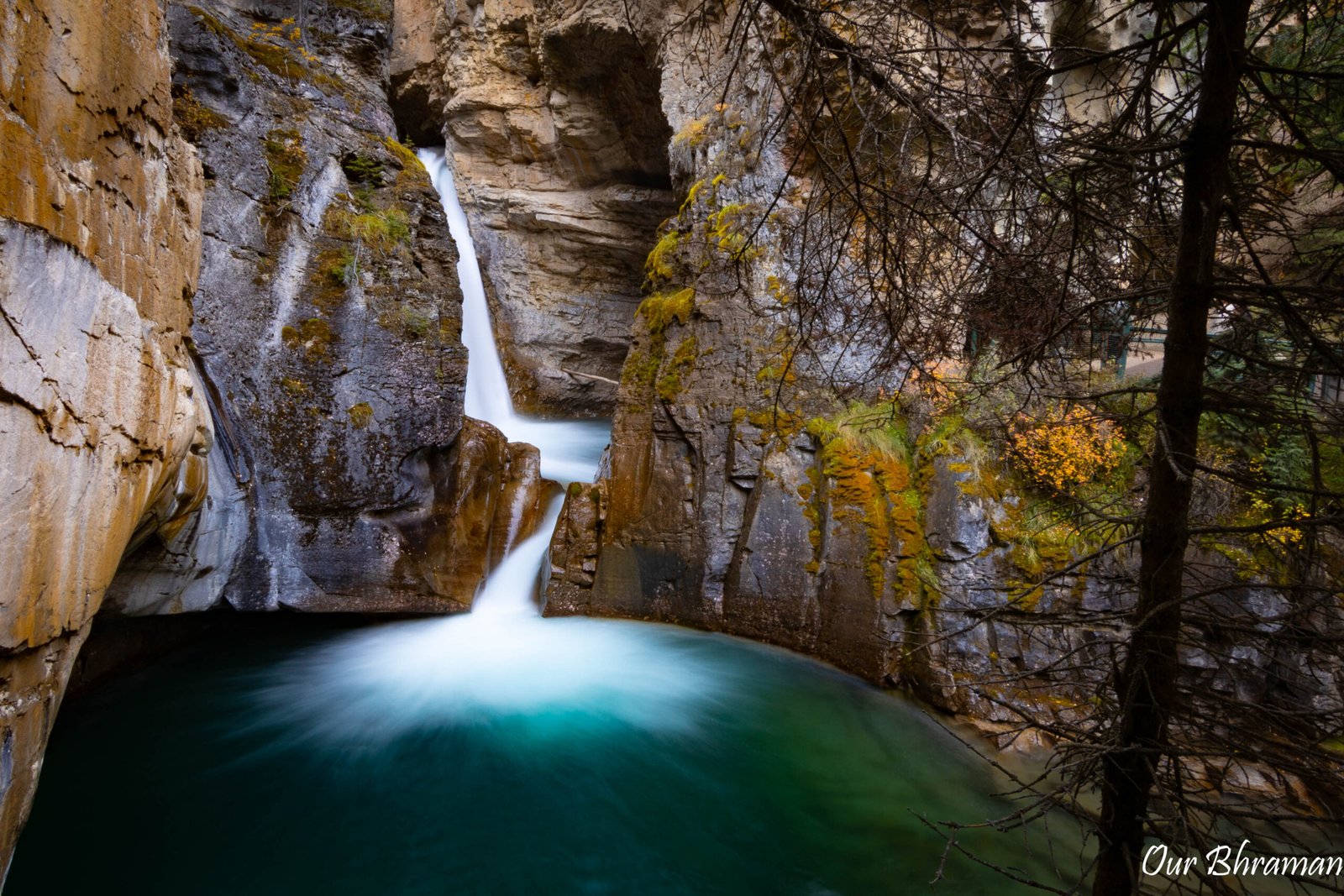 Lower Falls along Johnston Creek. The canyon is a very popular destination, famous for its well-maintained hiking trail that utilizes elevated steel catwalks built directly into the steep limestone canyon walls, allowing visitors to walk right over the rushing water and get close to several dramatic waterfalls.