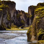 You are greeted with incredible views of the towering moss-covered cliffs and the winding Fjaðrá River far below
