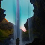 Kvernufoss, dropping nearly 100 feet over a lava rock cliff into a peaceful green canyon.