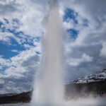 Witness Strokkur Geyser erupt every 10 to 15 minutes, sending boiling water shooting up to 65 feet (20 meters) into the air.