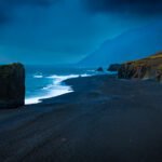 Stapi in Stapavík is a striking 20-meter-tall freestanding volcanic rock formation rising from a black pebble beach on Iceland's East Coast. Also known as the "cubic rock"