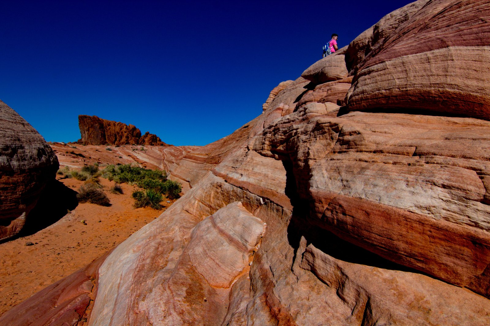 Valley of Fire State Park in Nevada, located about an hour northeast of Las Vegas, is famous for its massive, vibrant red Aztec sandstone formations, which were formed from shifting sand dunes over 150 million years ago. These dramatic landscapes are well-known for appearing to "glow" or look like they are on fire when the sun hits them, which is how the park earned its name.