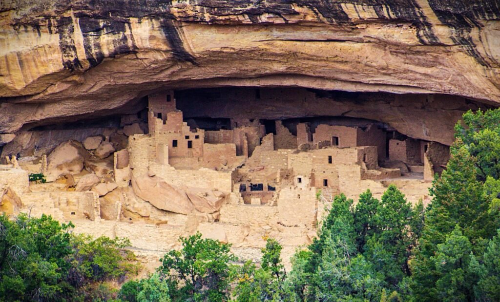 he ancient, multi-story stone brick ruins of Cliff Palace are nestled securely inside a massive sandstone alcove at Mesa verde National Park